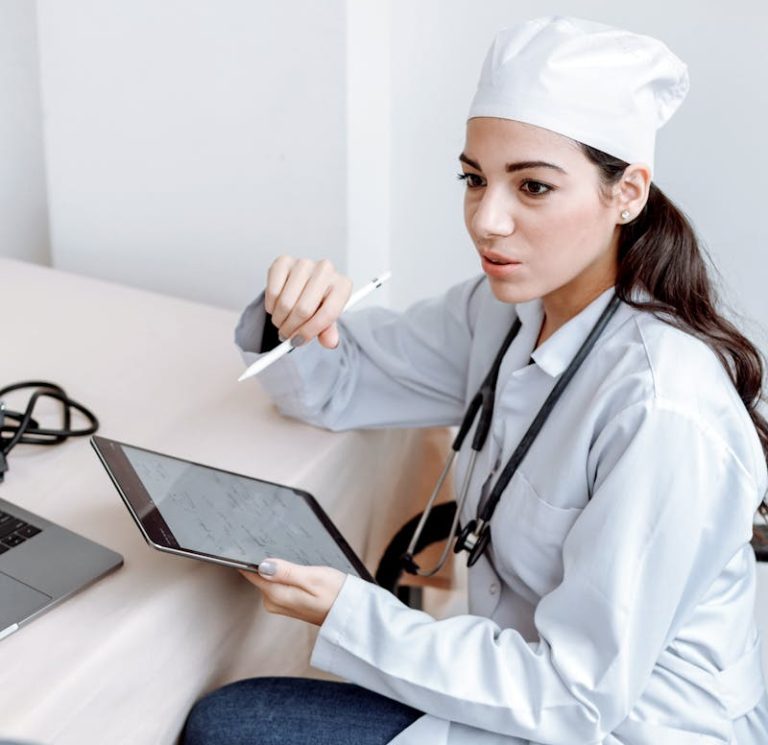 Medical Professional Sitting on a Chair Holding a Tablet while Talking